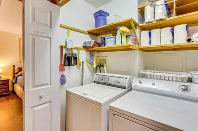a laundry room with a washing machine and cabinets at Charming Apartment with Yard and Beautiful Gardens! in Manheim