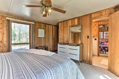 a bedroom with a bed and a ceiling fan at Walk to Big Bass Lake Family Home with Deck! in Gouldsboro