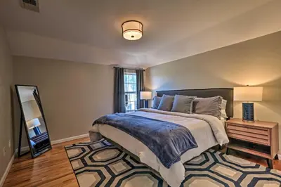 a bedroom with a large bed and a mirror at Modern Elizabeth Apt by Dining and NYC Transit! in Elizabeth