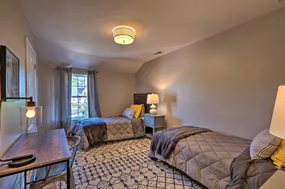 a bedroom with two beds and a table and a desk at Modern Elizabeth Apt by Dining and NYC Transit! in Elizabeth