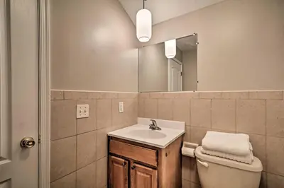 a bathroom with a sink and a toilet and a mirror at Modern Elizabeth Apt by Dining and NYC Transit! in Elizabeth