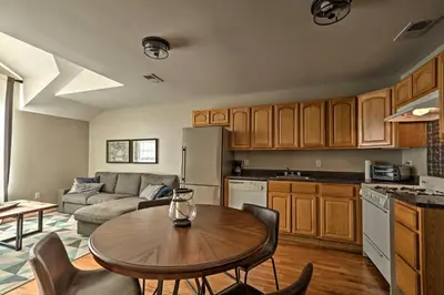 a kitchen and living room with a table and a couch at Modern Elizabeth Apt by Dining and NYC Transit! in Elizabeth