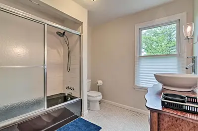 a bathroom with a shower and a sink and a toilet at Millburn House with Deck - Walk to NYC Transit! in Millburn