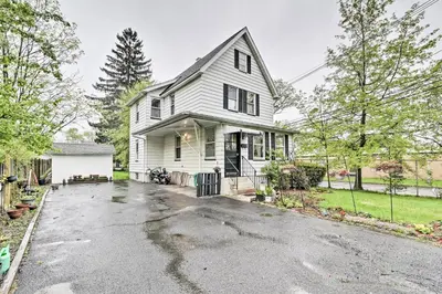 a white house with a driveway in front of it at Millburn House with Deck - Walk to NYC Transit! in Millburn