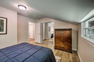 a bedroom with a bed and a dresser and a window at Hike, Hunt and Unwind Cozy Cabin Near Hersheypark in Jonestown