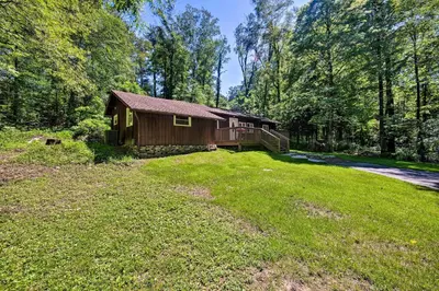 a house in the middle of a yard at Hike, Hunt and Unwind Cozy Cabin Near Hersheypark in Jonestown