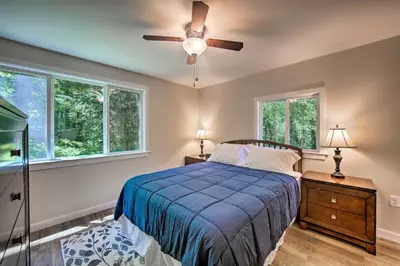 a bedroom with a bed and a ceiling fan at Hike, Hunt and Unwind Cozy Cabin Near Hersheypark in Jonestown