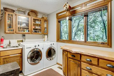 a laundry room with a washer and dryer at Luxe Poconos Pines Home with Beach and Amenities! in Pocono Pines