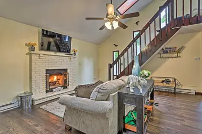 a living room with a couch and a fireplace at 15 Mi to Camelback Ski Resort Home with Deck! in Tobyhanna