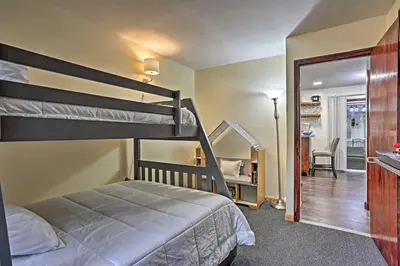 a bedroom with two bunk beds and a desk at 15 Mi to Camelback Ski Resort Home with Deck! in Tobyhanna