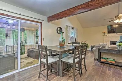 a dining room with a table and chairs at 15 Mi to Camelback Ski Resort Home with Deck! in Tobyhanna