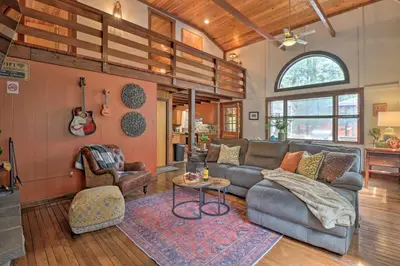 a living room with a couch and a table at Deck and Fire Pit Cozy Pocono Mountain Home in Lake Harmony