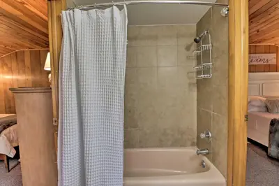 a bathroom with a shower and a bath tub at Deck and Fire Pit Cozy Pocono Mountain Home in Lake Harmony