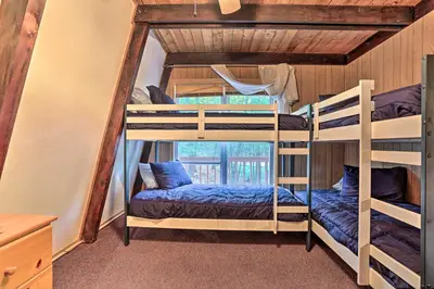 a bedroom with two bunk beds in a house at half Mi to Hideout Ski Lake Ariel Resort Home! in Lake Ariel