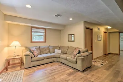 a living room with a couch and a table at Deck, Hot Tub and Game Room Lake Harmony Home in Lake Harmony