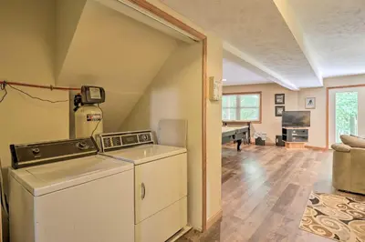 a washer and dryer in a living room at Deck, Hot Tub and Game Room Lake Harmony Home in Lake Harmony
