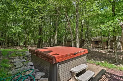 a small building with a red roof and two benches at Deck, Hot Tub and Game Room Lake Harmony Home in Lake Harmony