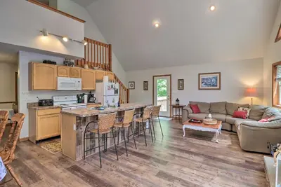 a kitchen and living room with a couch and a table at Deck, Hot Tub and Game Room Lake Harmony Home in Lake Harmony