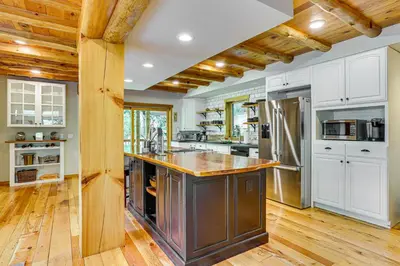 a kitchen with white cabinets and a wooden ceiling at Secluded Cabin with Boats Less Than 6 Mi to Jenny Jump! in Great Meadows