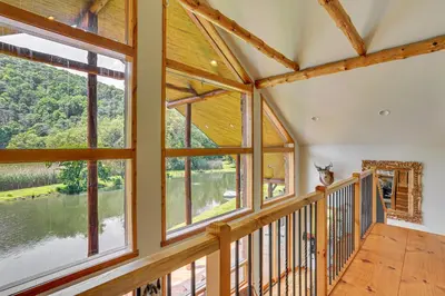 a large room with large windows and a balcony at Secluded Cabin with Boats Less Than 6 Mi to Jenny Jump! in Great Meadows
