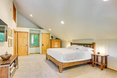 a bedroom with a large bed and a table at Secluded Cabin with Boats Less Than 6 Mi to Jenny Jump! in Great Meadows