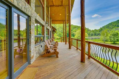 a porch of a building with rocking chairs on it at Secluded Cabin with Boats Less Than 6 Mi to Jenny Jump! in Great Meadows