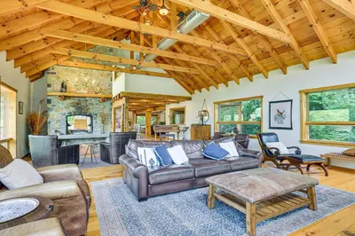 a living room with a couch and a table at Secluded Cabin with Boats Less Than 6 Mi to Jenny Jump! in Great Meadows