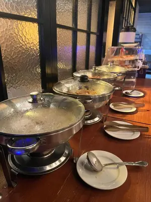a row of pans on a table with spoons at Four Points by Sheraton New York Downtown in New York