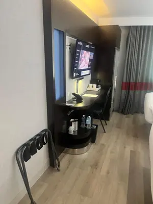 a hotel room with a desk and a television at Four Points by Sheraton New York Downtown in New York