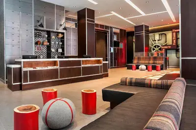 a lobby of a hotel with a couch and a bar at Four Points by Sheraton New York Downtown in New York
