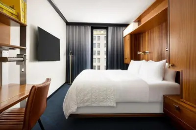 a hotel room with a bed and a desk at Le Meridien New York, Central Park in New York