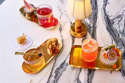 a table topped with plates of food and drinks at Le Meridien New York, Central Park in New York