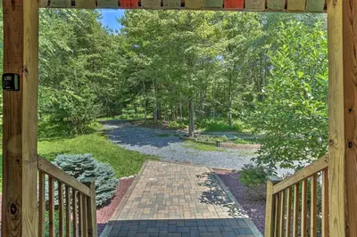 a door to a porch with a walkway at Palmerton Cabin with Game Room about 5 Mi to Blue Mtn in Palmerton