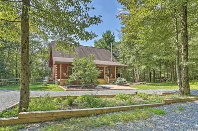 a log cabin in the woods with trees at Palmerton Cabin with Game Room about 5 Mi to Blue Mtn in Palmerton