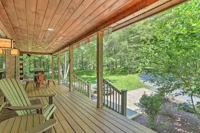 a porch with two chairs and a table on it at Palmerton Cabin with Game Room about 5 Mi to Blue Mtn in Palmerton