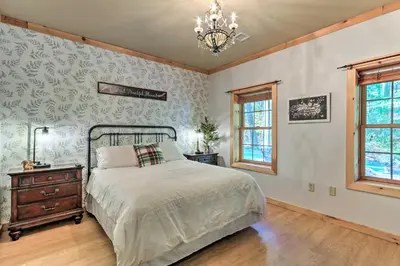 a bedroom with a bed and a chandelier at Expansive Group Getaway 11 Mi to Lancaster! in New Providence