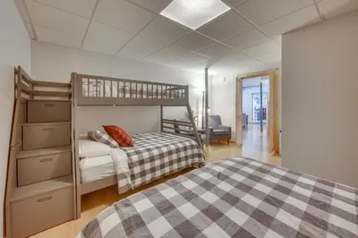 a bedroom with two bunk beds and a desk at Expansive Group Getaway 11 Mi to Lancaster! in New Providence
