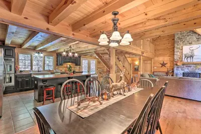 a dining room with a table and a kitchen at Expansive Group Getaway 11 Mi to Lancaster! in New Providence