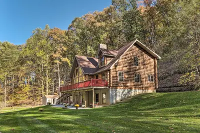 a large house on a grassy hill with trees at Expansive Group Getaway 11 Mi to Lancaster! in New Providence