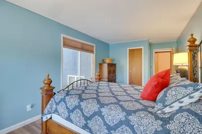 a blue bedroom with a bed with red pillows at Near Skiing Lakefront Gem with Kayaks in Long Pond in Long Pond