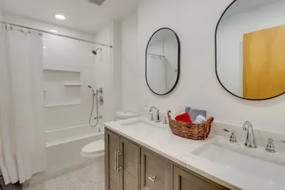 a bathroom with a sink and a toilet and a mirror at Near Skiing Lakefront Gem with Kayaks in Long Pond in Long Pond