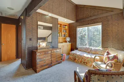 a living room with a couch and a mirror at Near Skiing Lakefront Gem with Kayaks in Long Pond in Long Pond