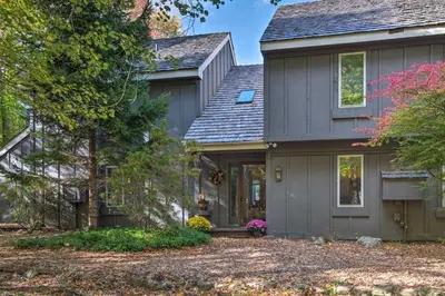 a home with a gray house at 1 Mi to Jack Frost Ski Resort Water-View Retreat in Lake Harmony