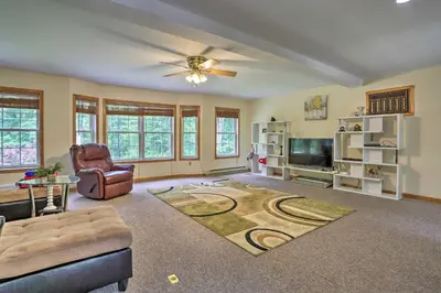 a living room with a couch and a tv at 5 Mi to Camelback Henryville Home with Hot Tub! in Henryville