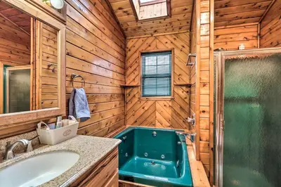 a bathroom with a tub and a sink at 5 Mi to Camelback Henryville Home with Hot Tub! in Henryville