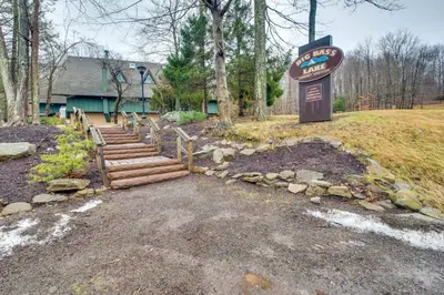 a welcome sign and stairs in front of a building at Fire Pit and Community Perks Gouldsboro Cabin! in Gouldsboro