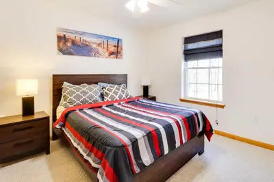 a bedroom with a bed and a window at Deck, Game Room and Fire Pit Poconos Retreat in Albrightsville