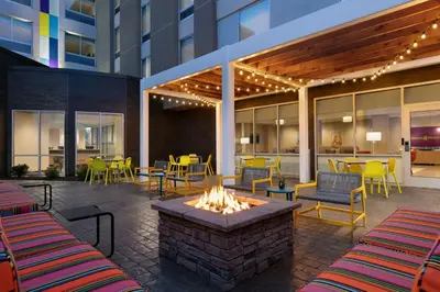 a patio with a fire pit and tables and chairs at Tru By Hilton Easton in Easton