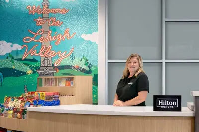 a woman standing behind a counter in a store at Tru By Hilton Easton in Easton