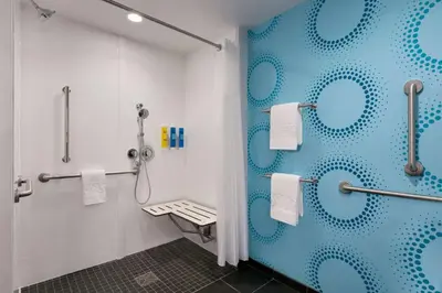 a bathroom with a shower with blue circles on the wall at Tru By Hilton Easton in Easton